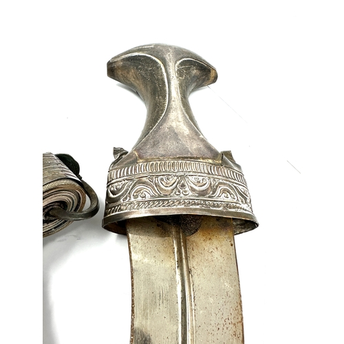 472 - Eastern Jambiya dagger The blade measuring 15 cm long. finely worked white metal and leather. Set wi... 