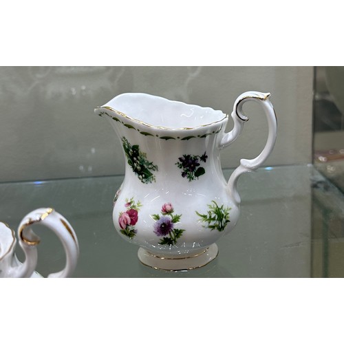 297 - Royal Albert Flower Of The Month Teapot, cream and sugar set, all Second quality, good overall condi... 