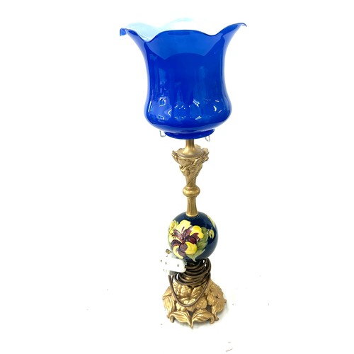 296 - Moorcroft table lamp with a blue glass shade in working order overall height 24 inches tall