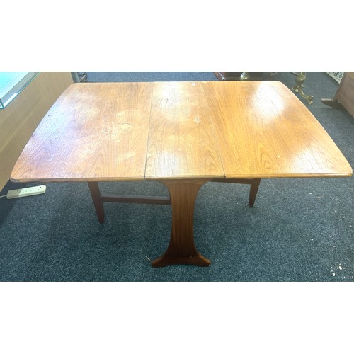 396 - Teak drop leaf table measures 54 wide, 36 deep and 29 high