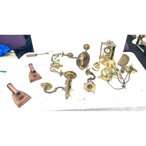 345 - Selection of brass items to include candle holders, clock, oil lamp, flat irons, cutlery etc