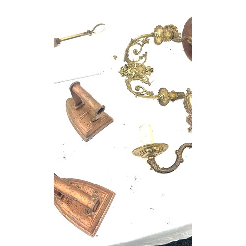 345 - Selection of brass items to include candle holders, clock, oil lamp, flat irons, cutlery etc