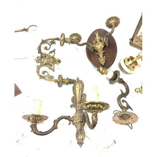 345 - Selection of brass items to include candle holders, clock, oil lamp, flat irons, cutlery etc