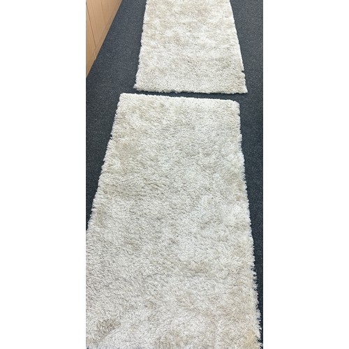 285 - Pair cream Shimmer lounge rugs, approximate measures of each 60 x 32 inches