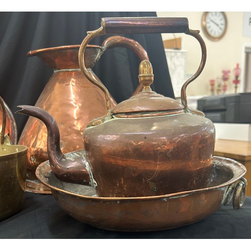 97 - Selection of copper and brassware to include a bed warming pan, large jug, kettle etc, jug measures ... 