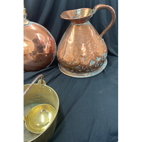 97 - Selection of copper and brassware to include a bed warming pan, large jug, kettle etc, jug measures ... 