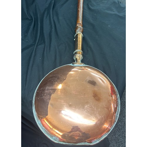 97 - Selection of copper and brassware to include a bed warming pan, large jug, kettle etc, jug measures ... 