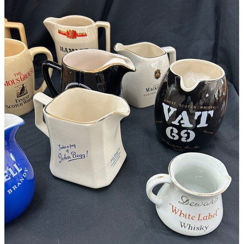 77 - Selection of 12 vintage advertising jugs