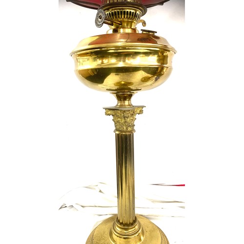 228 - Pair of brass oil lamps, complete with shades, height approximately 29 inches tall