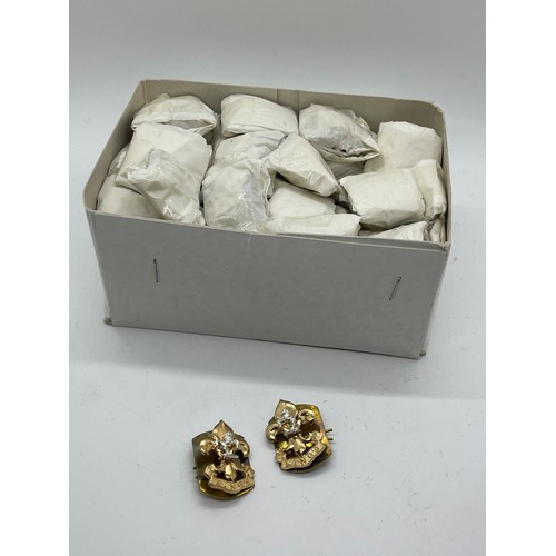 511 - Dealers lot of 50 pairs of King's Regiment collar badges complete with backing plates and pins