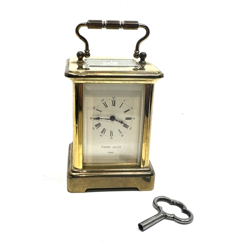 444 - Pierre jacot Paris carriage clock measures approx height 8cm by 5.7cm wide working order with key