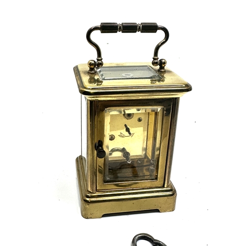 444 - Pierre jacot Paris carriage clock measures approx height 8cm by 5.7cm wide working order with key