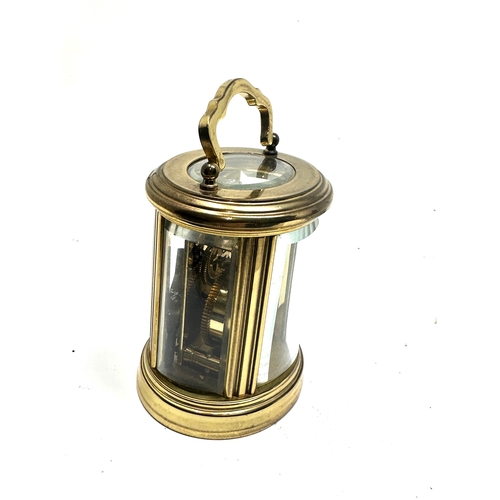 446 - brass carriage clock the clock is in working order measures approx 8cm high not including handle bow... 