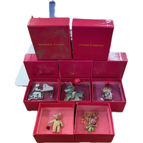 522 - Selection of 5 boxed Butler and Wilson pieces to include brooches/badges/ necklace