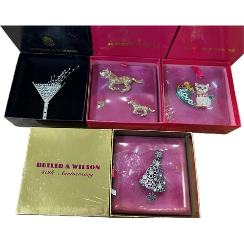 523 - Selection of 4 boxed Butler and Wilson pieces to include brooches/badges