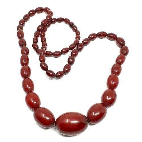 63 - Vintage cherry amber bakelite necklace with good interenal streaking measures approx largest bead 3.... 