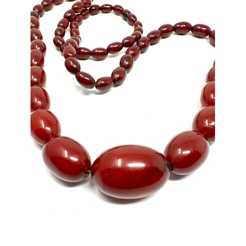 63 - Vintage cherry amber bakelite necklace with good interenal streaking measures approx largest bead 3.... 