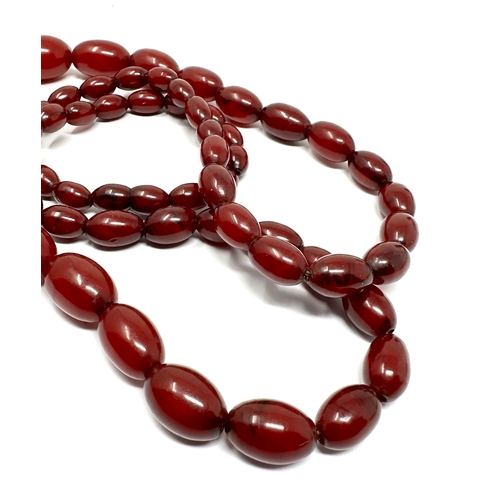 63 - Vintage cherry amber bakelite necklace with good interenal streaking measures approx largest bead 3.... 