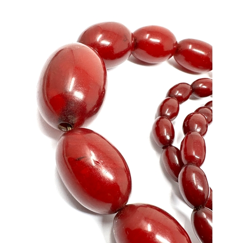 63 - Vintage cherry amber bakelite necklace with good interenal streaking measures approx largest bead 3.... 