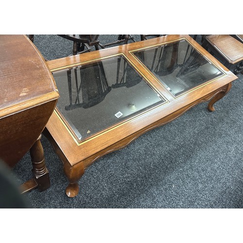 299 - Glass topped coffee table measures approximately