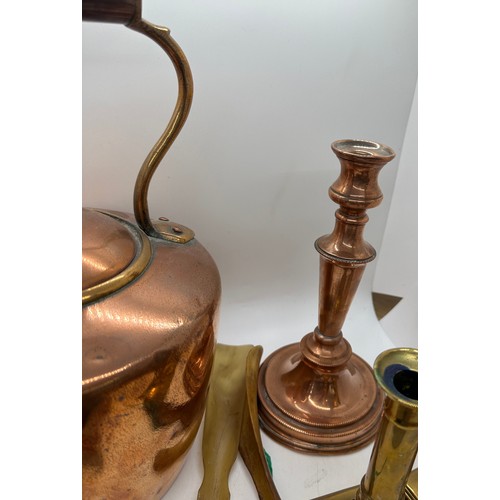 59 - Selection of metal ware to include a copper kettle and candle stick, pair of brass candle sticks and... 