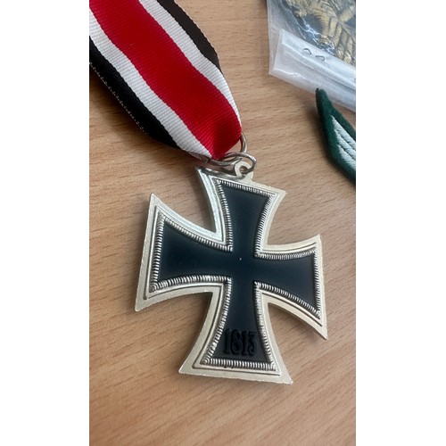 483 - Selection of reproduction German WWII items including 3 Iron Crosses, War medal, brass Gestapo badge... 