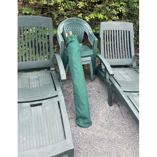 100M - Two plastic sun loungers and four green plastic chairs