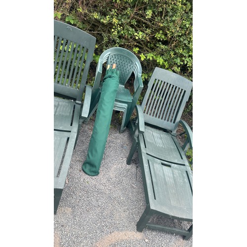 100M - Two plastic sun loungers and four green plastic chairs