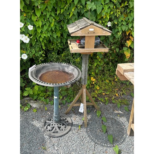 101C - Wooden bird feeder measures approx 46 inches tall and a plastic bird feeder