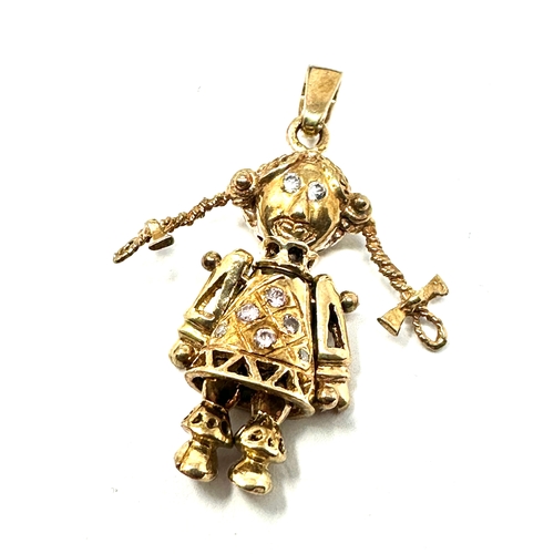 107 - 9ct gold jointed doll pendant set with gemstones weight 4.5g