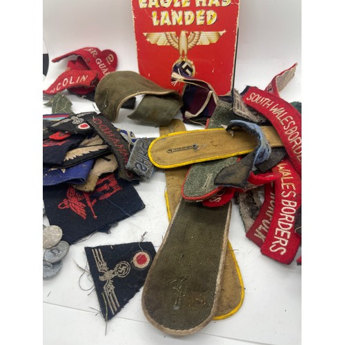 555 - Tin containing a quantity of WW2 era cloth patches including NZ airforce, Royal Winnipeg rifles, gre... 