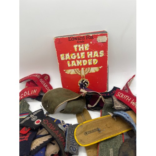 555 - Tin containing a quantity of WW2 era cloth patches including NZ airforce, Royal Winnipeg rifles, gre... 