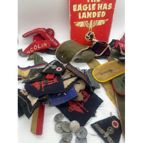 555 - Tin containing a quantity of WW2 era cloth patches including NZ airforce, Royal Winnipeg rifles, gre... 