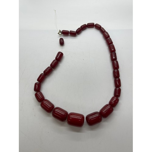 504 - Art deco cherry red amber bakelite beads with internal streaking. Barrel shaped beads weighs approx ... 