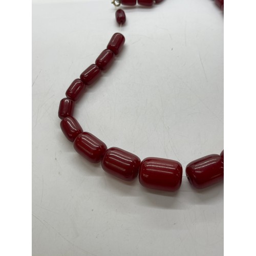 504 - Art deco cherry red amber bakelite beads with internal streaking. Barrel shaped beads weighs approx ... 