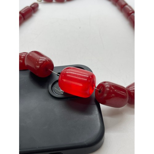 504 - Art deco cherry red amber bakelite beads with internal streaking. Barrel shaped beads weighs approx ... 