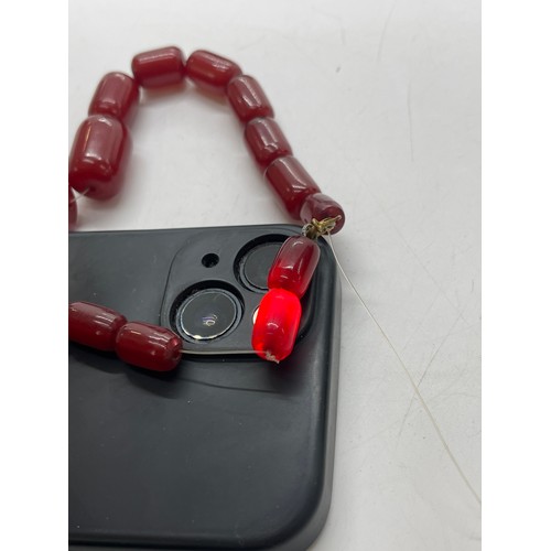 504 - Art deco cherry red amber bakelite beads with internal streaking. Barrel shaped beads weighs approx ... 