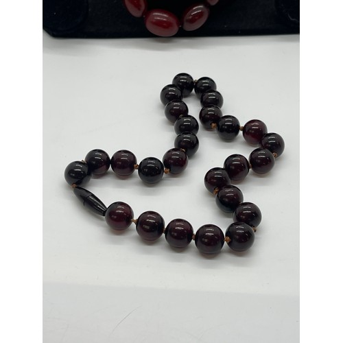 496 - Vintage cherry red amber bakelite beads weigh approx 34 grams with internal streaking and another ne... 