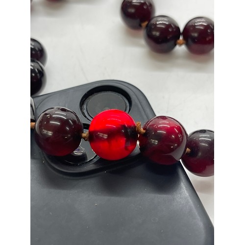 496 - Vintage cherry red amber bakelite beads weigh approx 34 grams with internal streaking and another ne... 