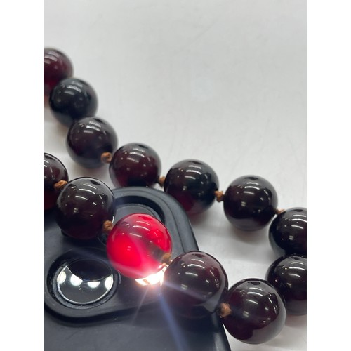 496 - Vintage cherry red amber bakelite beads weigh approx 34 grams with internal streaking and another ne... 