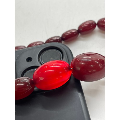 496 - Vintage cherry red amber bakelite beads weigh approx 34 grams with internal streaking and another ne... 