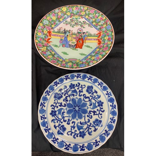 574 - 2 Oriental plates/ chargers largest measures approximately 17.5 inches