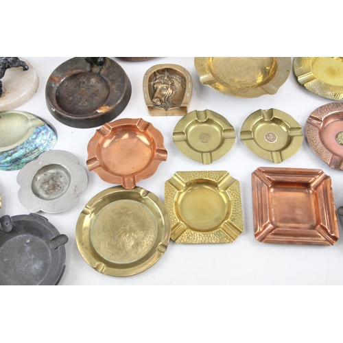 76 - Selection of ashtrays to include vintage decorative novelty, Onyx, Brass, Copper, Advertising etc