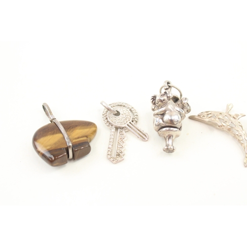 435 - A collection of novelty silver pendants including a touchwood (57g)