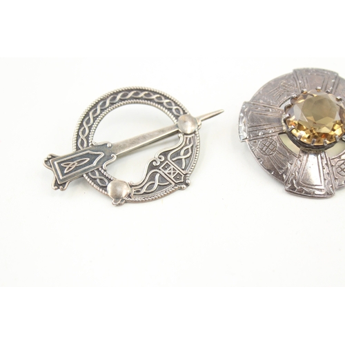 439 - Four silver Scottish brooches including a pennanular (43g)