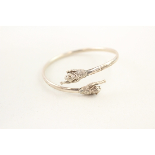 477 - Two silver bypass bangles (23g)