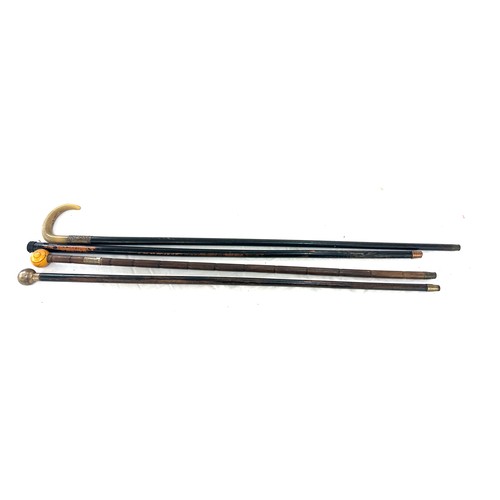 60 - Four silver topped walking sticks