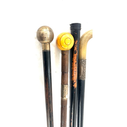 60 - Four silver topped walking sticks