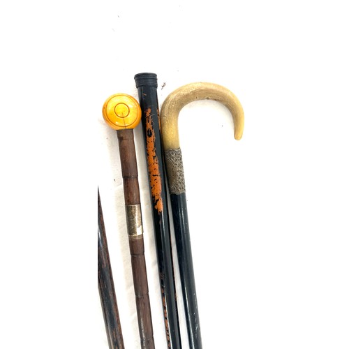 60 - Four silver topped walking sticks