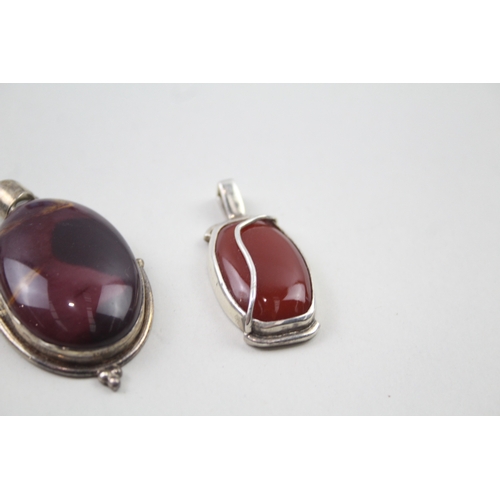 394 - Four silver gemstone pendants including Mookaite (67g)